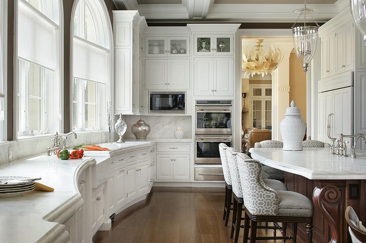 A traditional-style kitchen with curved countertops.