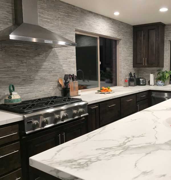What are Dekton Countertops? They Can resemble quartz like in this kitchen with white counters with grey marbling throughout.