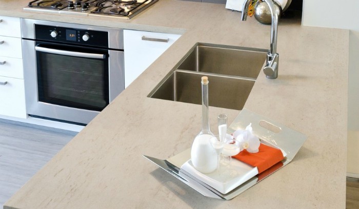 A stage photo of a welcome tray on sand-colored Dekton countertops.