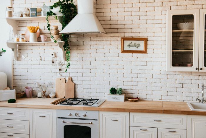A country-style kitchen with a stone backsplash.