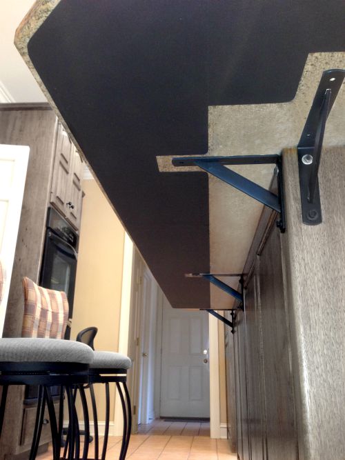 underside view of countertop overhang with heating mat attached