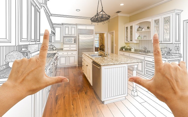 person holding up their hands in the shape of "L's" envisioning new kitchen layout