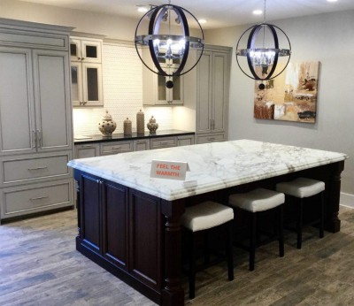 modern kitchen with white stone countertop and pull out barstools with black globe chandeliers