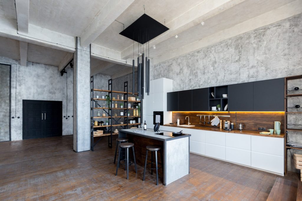 An industrial kitchen featuring concrete walls and clean lines.