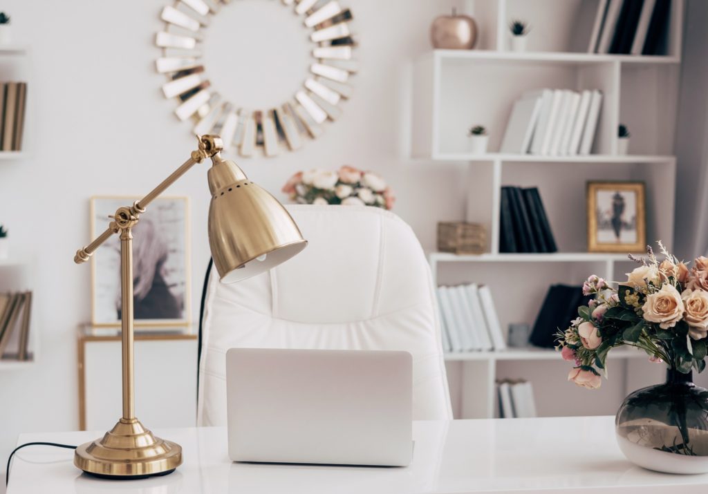Gold desk lamp on a white stone desk