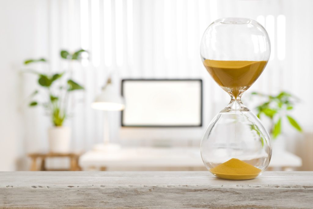 An hourglass with yellow sand 