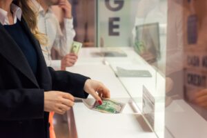 A customer getting money from a teller at a bank