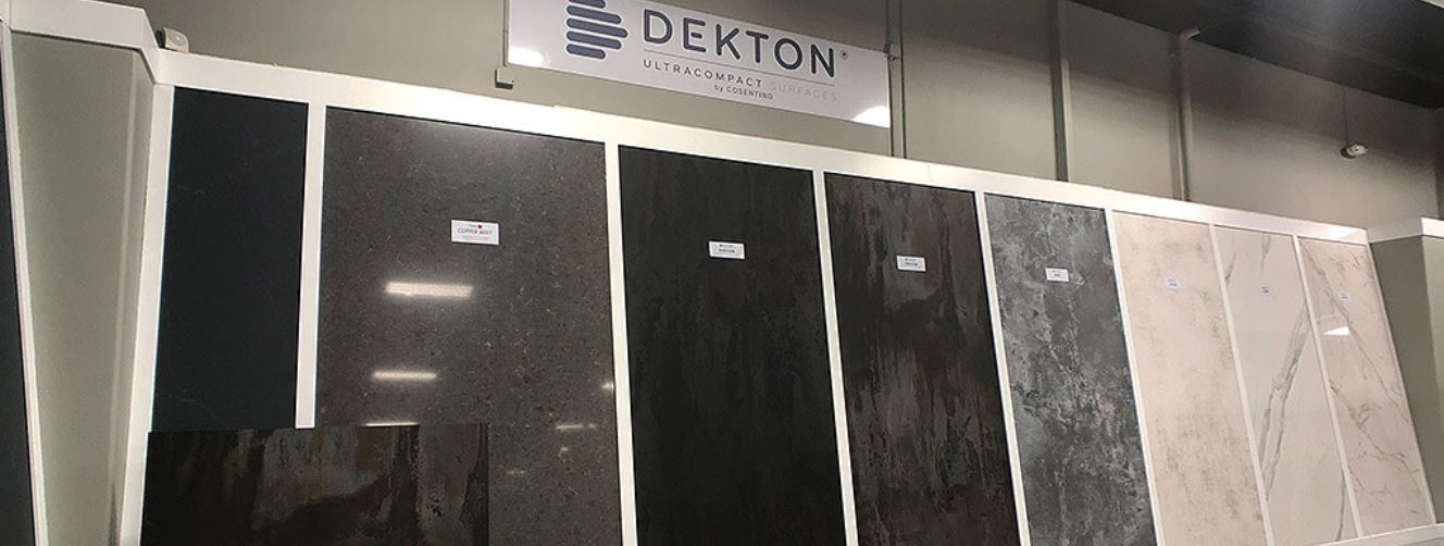 Various color options for Dekton counter tops that resemble stone in a showroom.