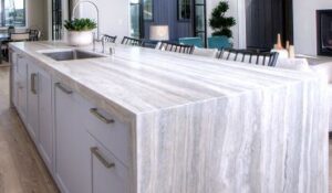 long stone island countertop with white drawers