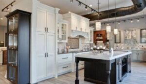 large modern kitchen with white cabinets and track lighting