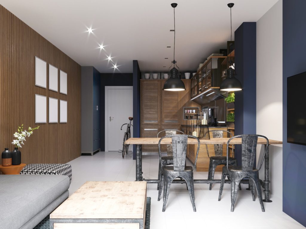 An industrial kitchen with deep blue accent walls.