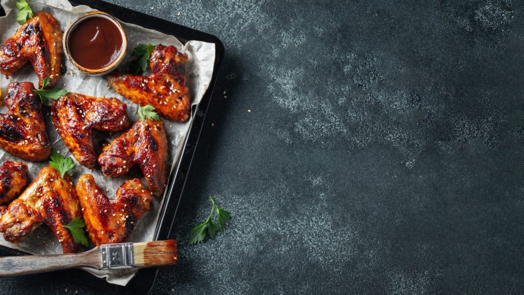 Warm chicken wings on a dark stone countertop